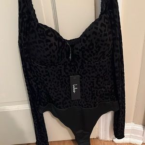 Size small black cheetah bodysuit. Tags on